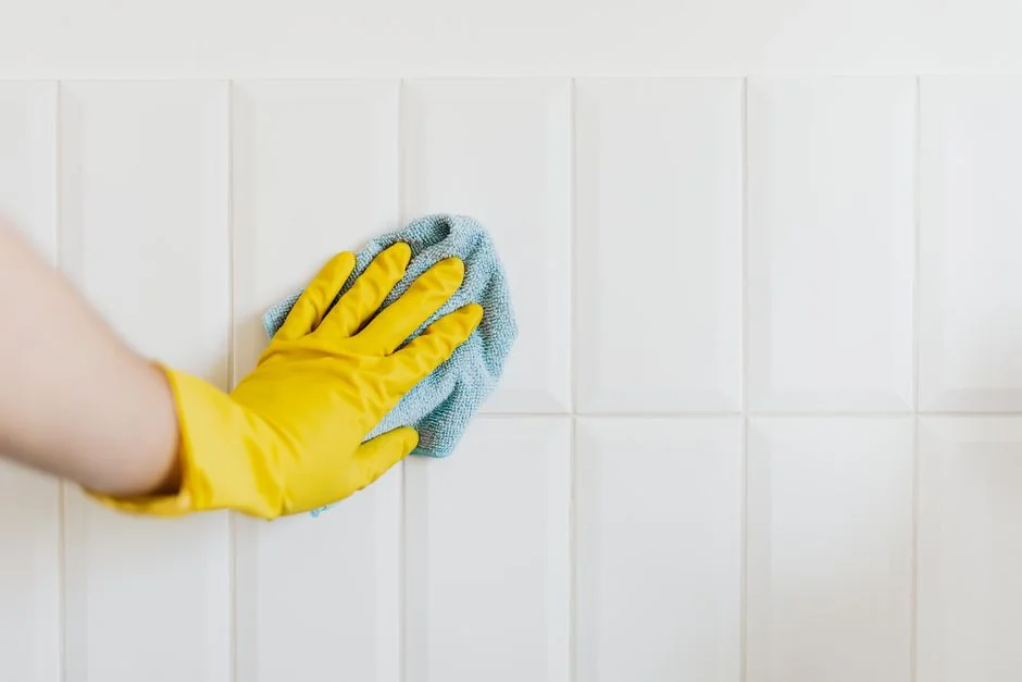 Woman wrapping a sofa with plastic for moving in a bright living room.